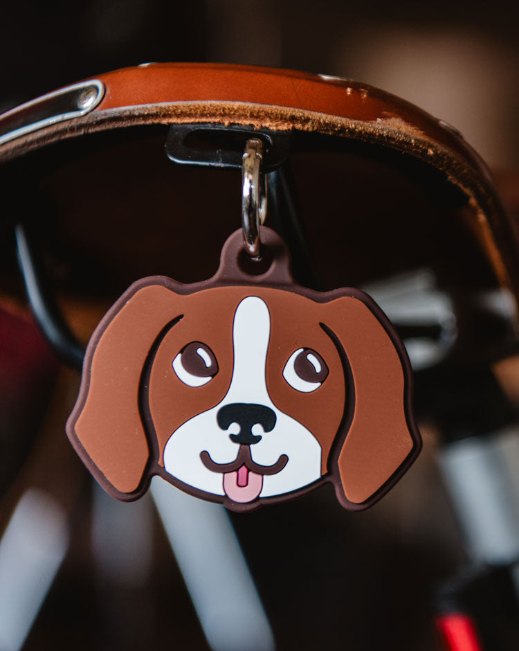 Herschel Supply Co. Brown Dog Bag Charm, a plush dog-shaped accessory with a classic patterned ear detail.