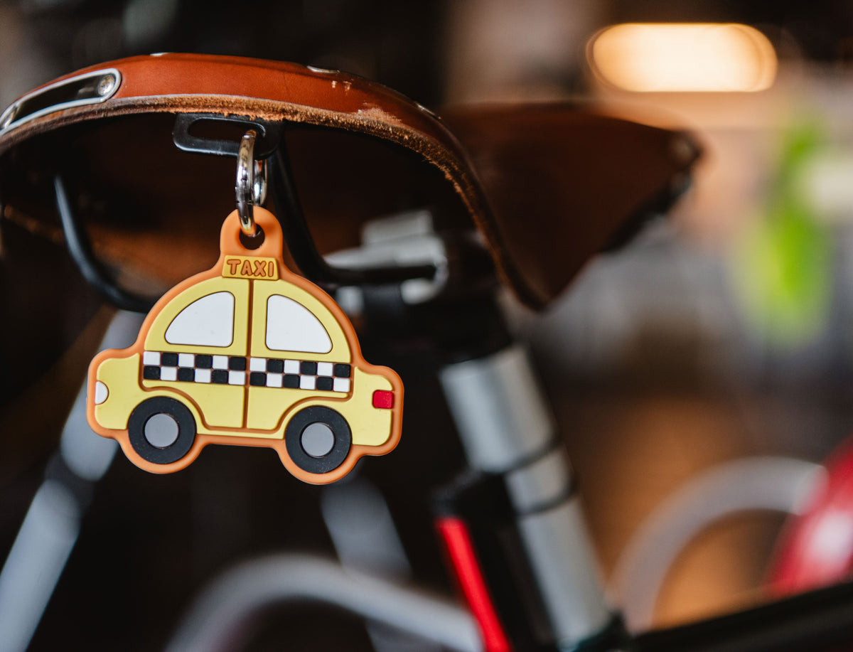 Herschel Supply Co. yellow checkered taxi cab silicone bag charm featuring a metal keyring for easy attachment.