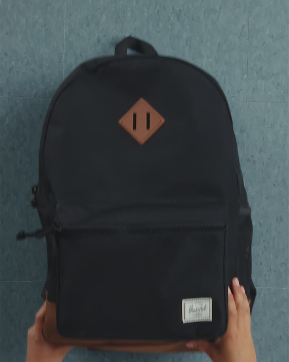 A Herschel Heritage Youth Backpack shown in a dynamic video showcasing all available vibrant color options.