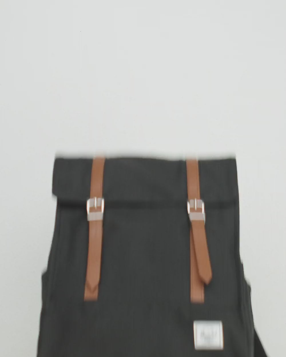 Herschel Survey Backpack in a multi-color design featuring a minimalist flap closure and slender profile.