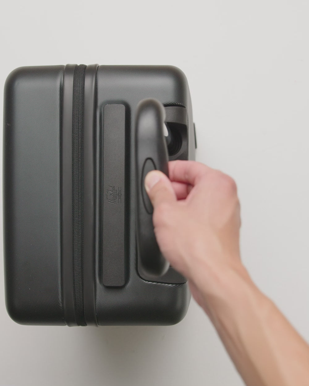 Herschel Heritage Hardshell Carry On Luggage, showcasing its durable hardshell exterior and sleek design.